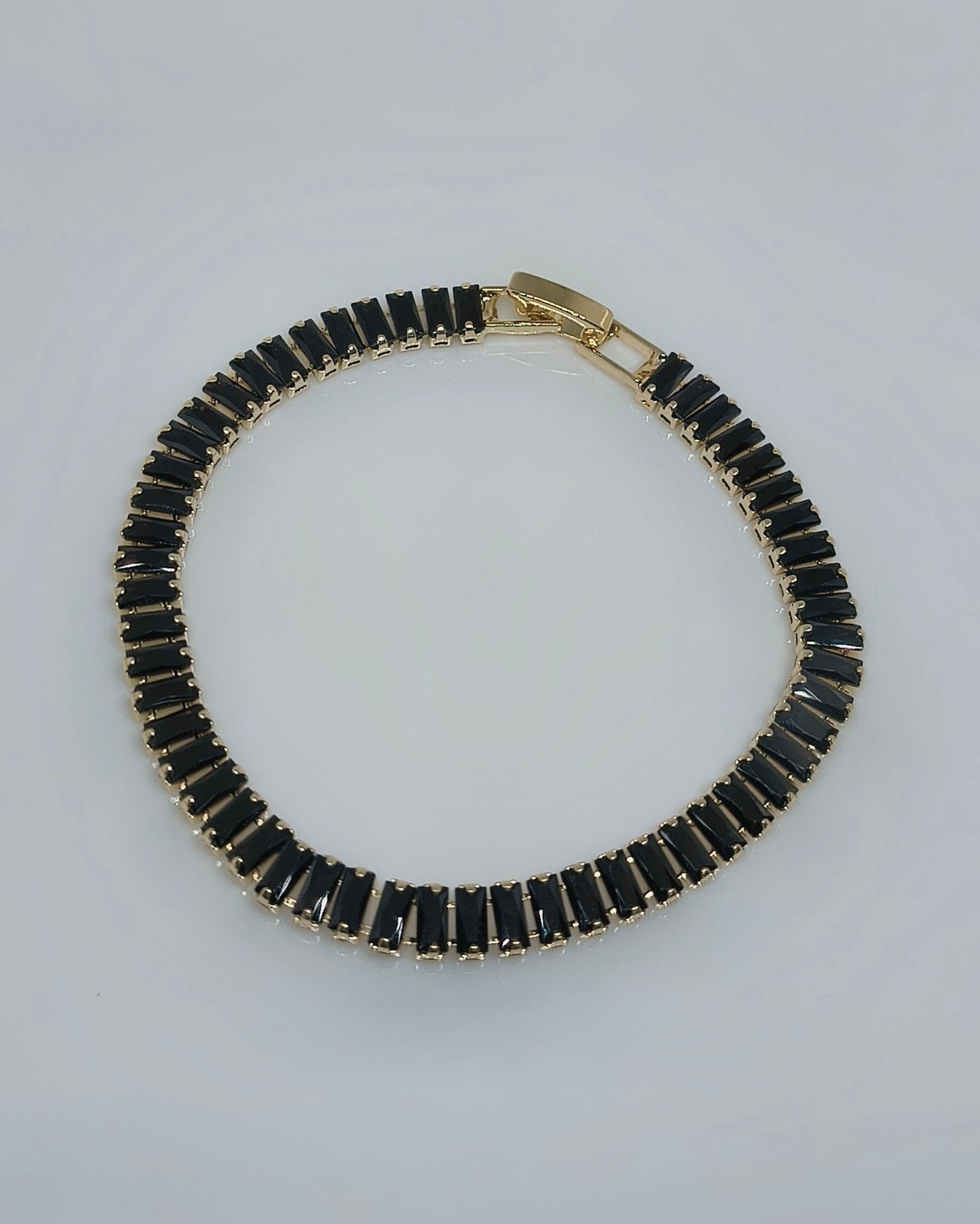 Black with gold color tone tennis bracelet