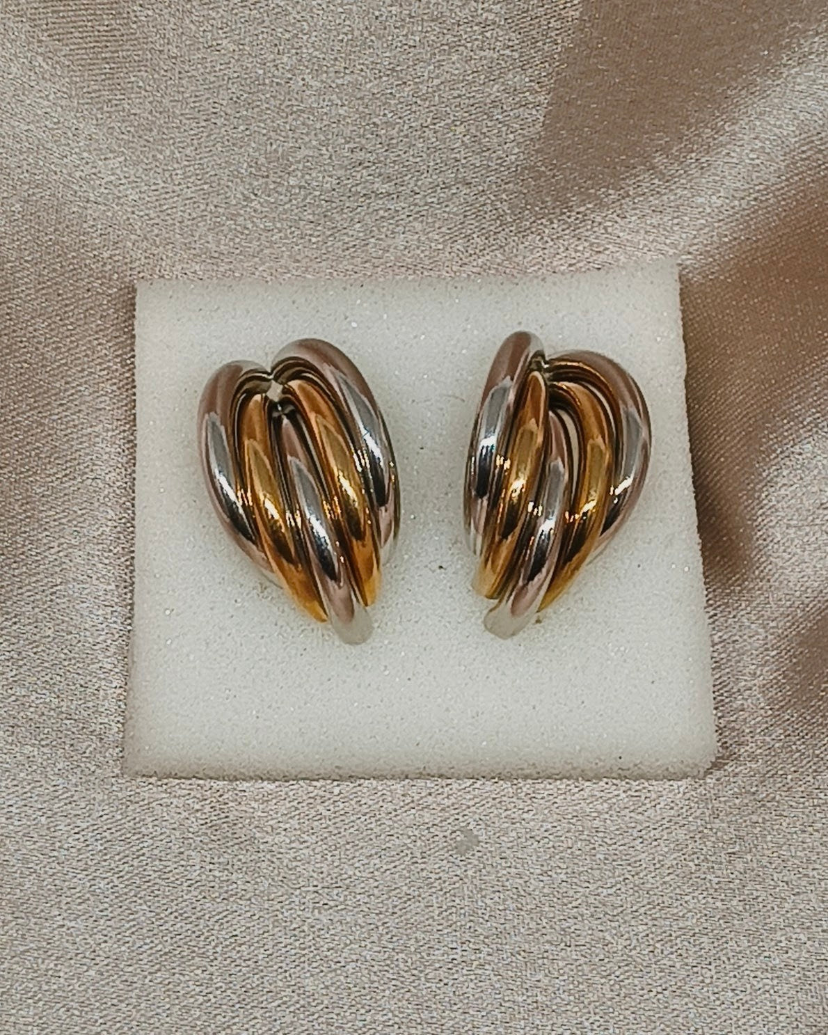 Dual tone swirl hoop earrings