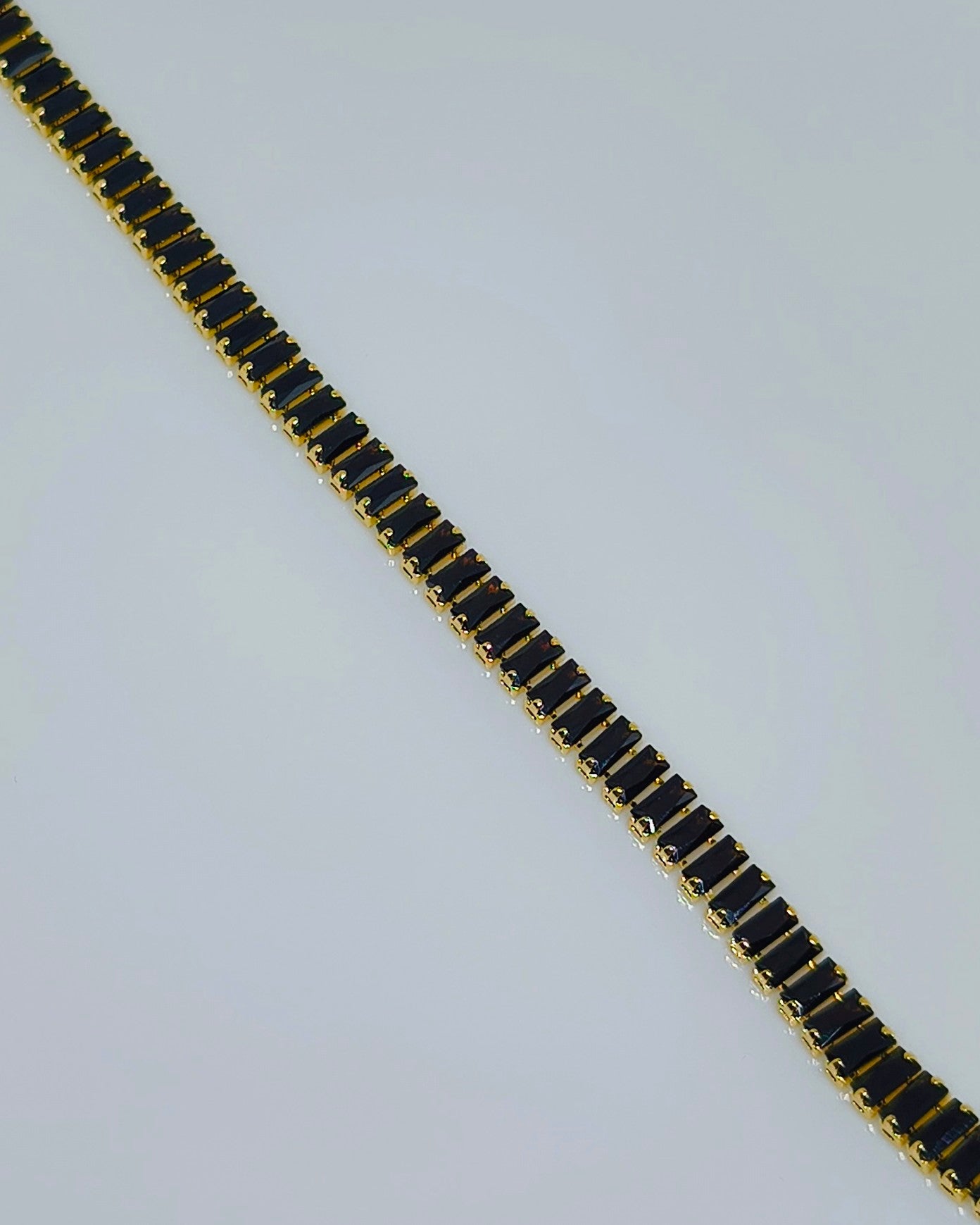 Black with gold color tone tennis bracelet