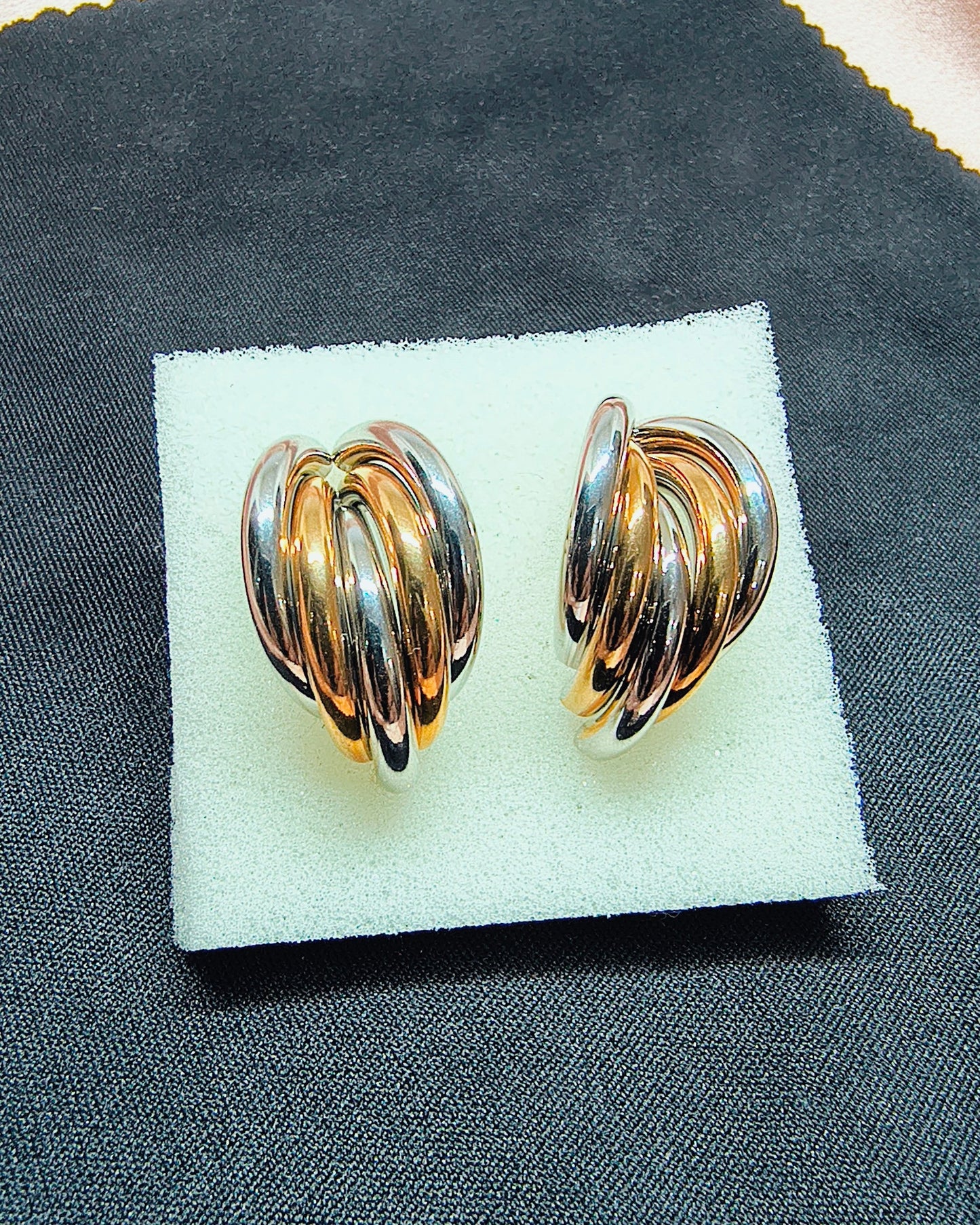 Dual tone swirl hoop earrings