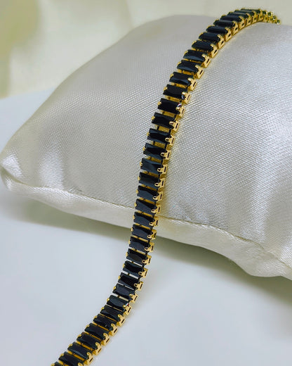 Black with gold color tone tennis bracelet